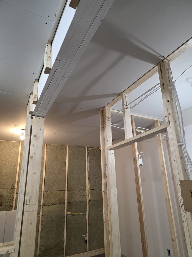 Chinook Glow drywall — ceiling boards going up in service rooms