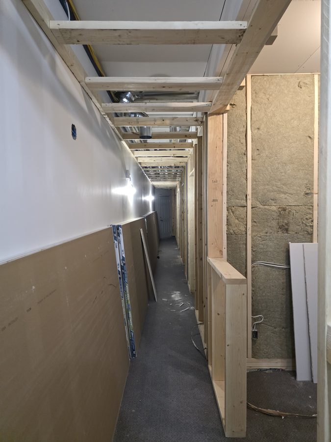 Chinook Glow drywall — sheets staged in corridor
