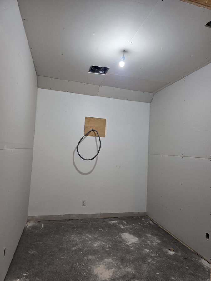 Chinook Glow drywall — service room fully boarded with outlet roughed in