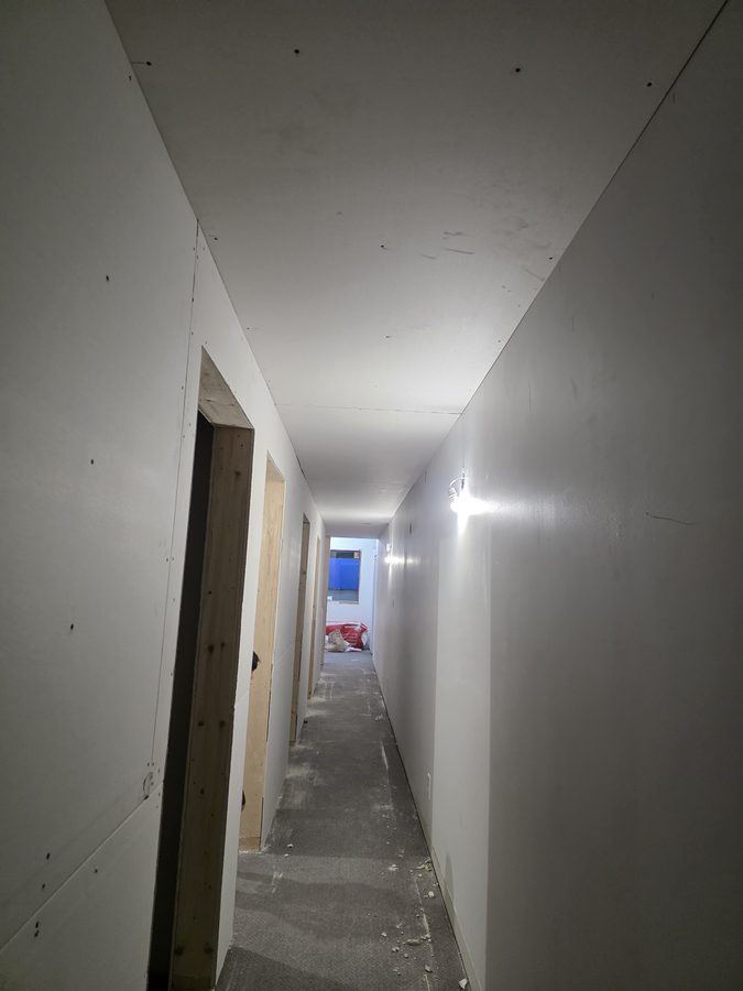 Chinook Glow drywall — corridor with service room doors visible