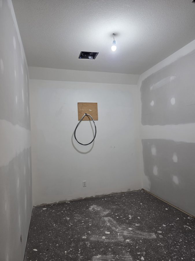 Chinook Glow drywall complete — tanning room fully finished and primed
