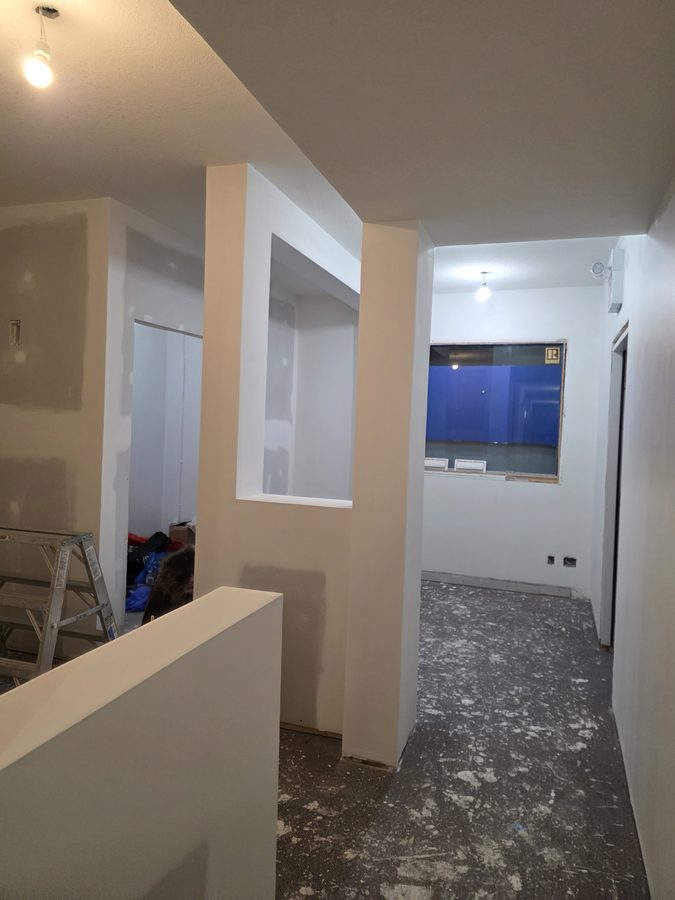 Chinook Glow drywall complete — reception with windows framed out