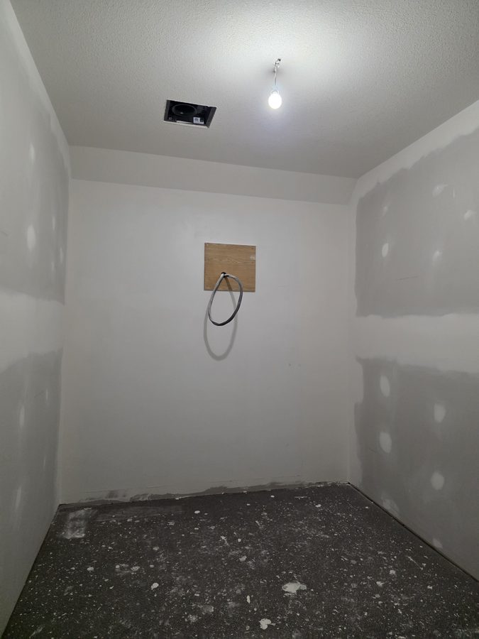 Chinook Glow drywall complete — tanning room primed