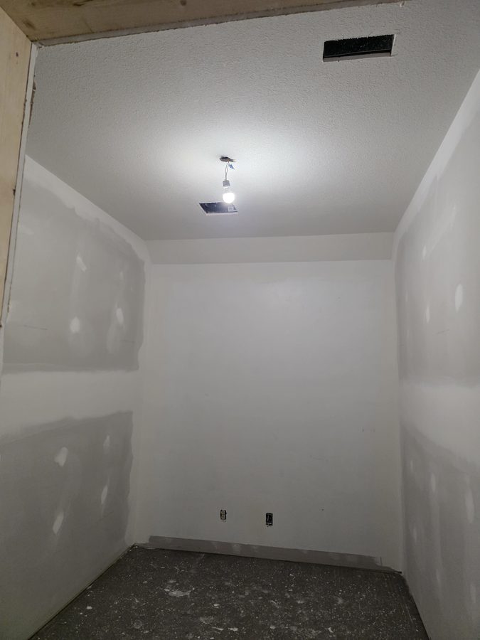 Chinook Glow drywall complete — service room fully primed