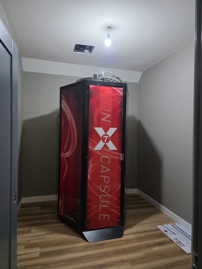 SunCapsule X7 tanning booth installed in its room at Chinook Glow Raymond AB
