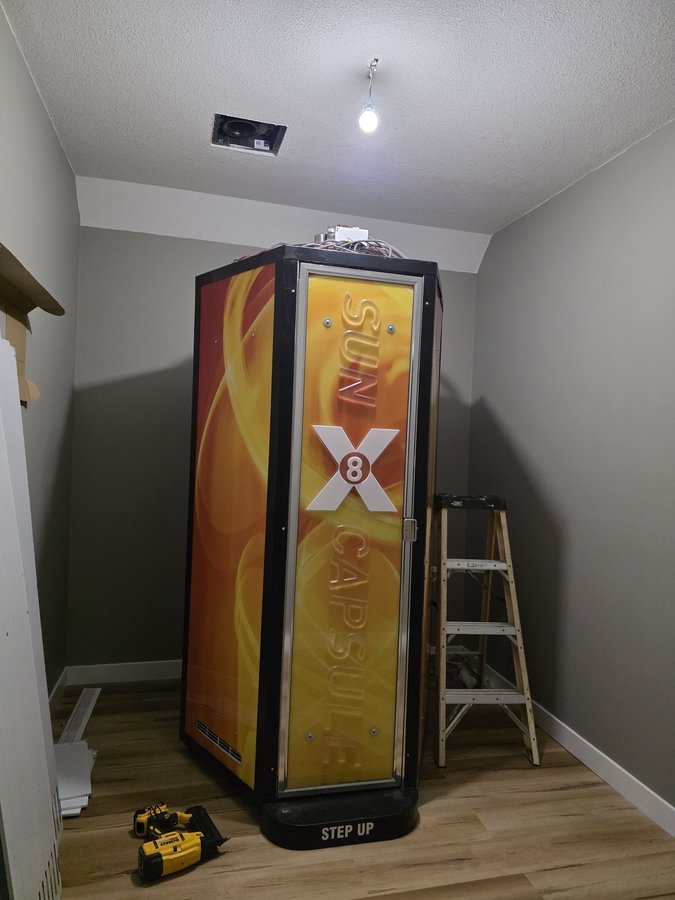 SunCapsule X8 tanning booth installed in its room at Chinook Glow Raymond AB