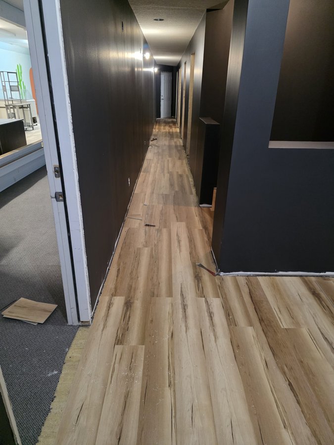Chinook Glow flooring — LVP plank install starting in the corridor