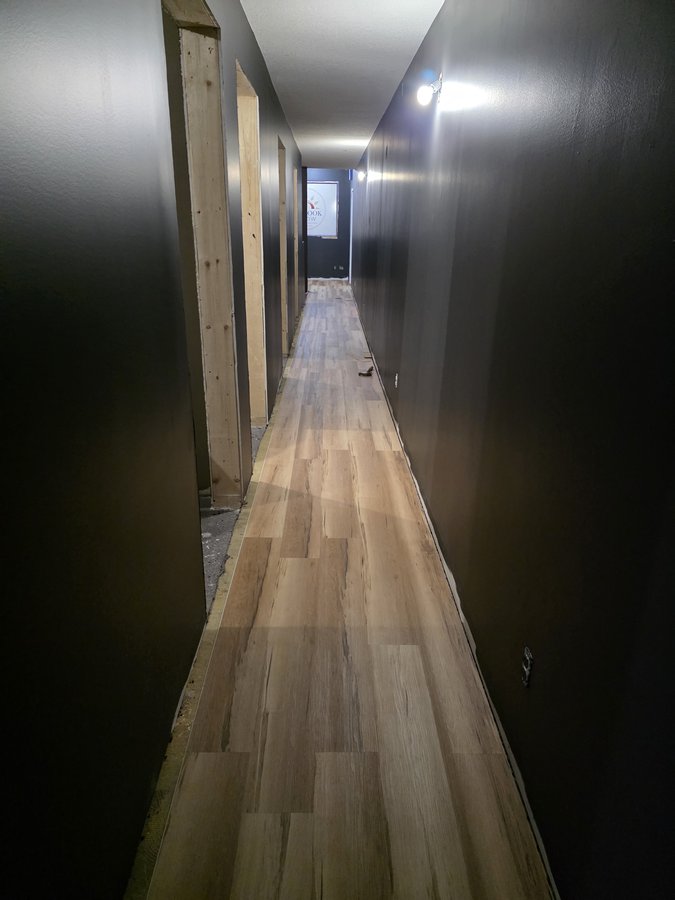 Chinook Glow flooring — corridor LVP install in progress