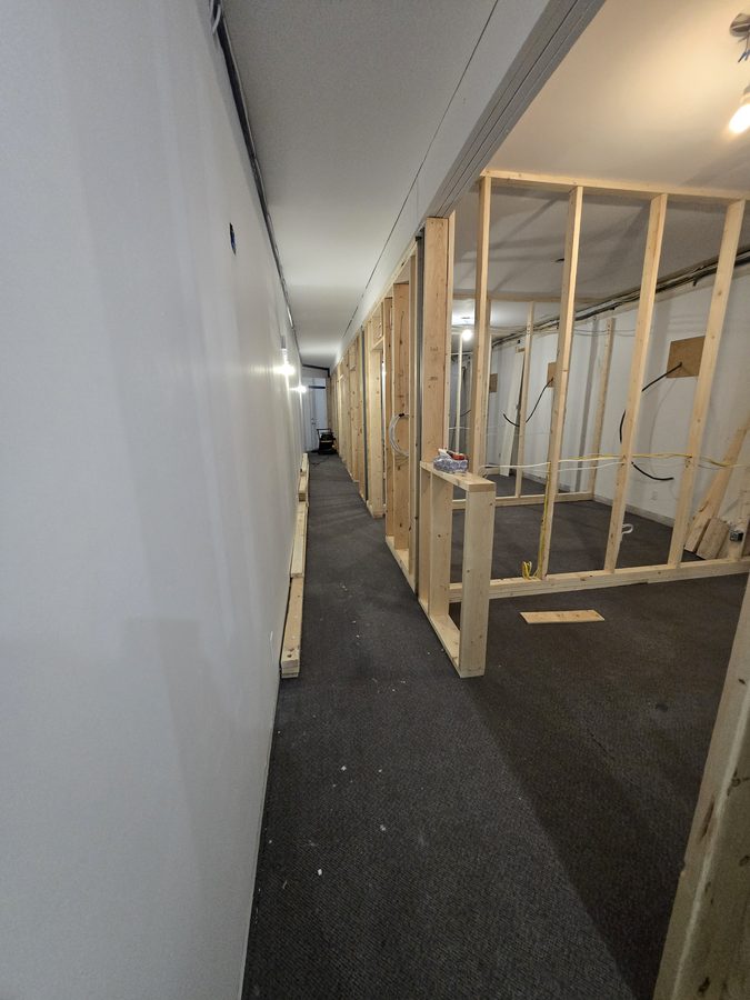 Chinook Glow wall framing — corridor view with service rooms taking shape