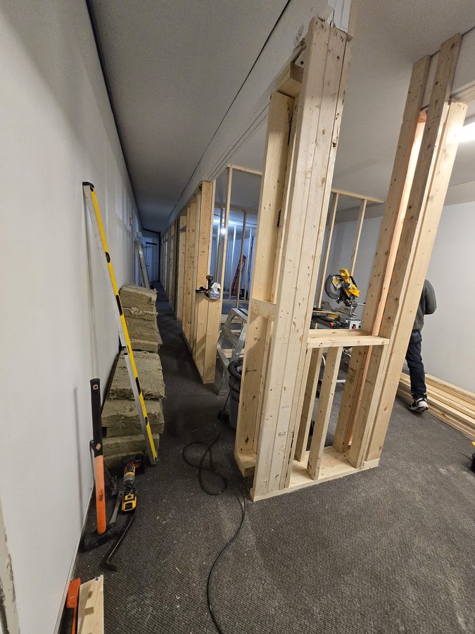 Chinook Glow framing — insulation batts staged, room openings roughed in