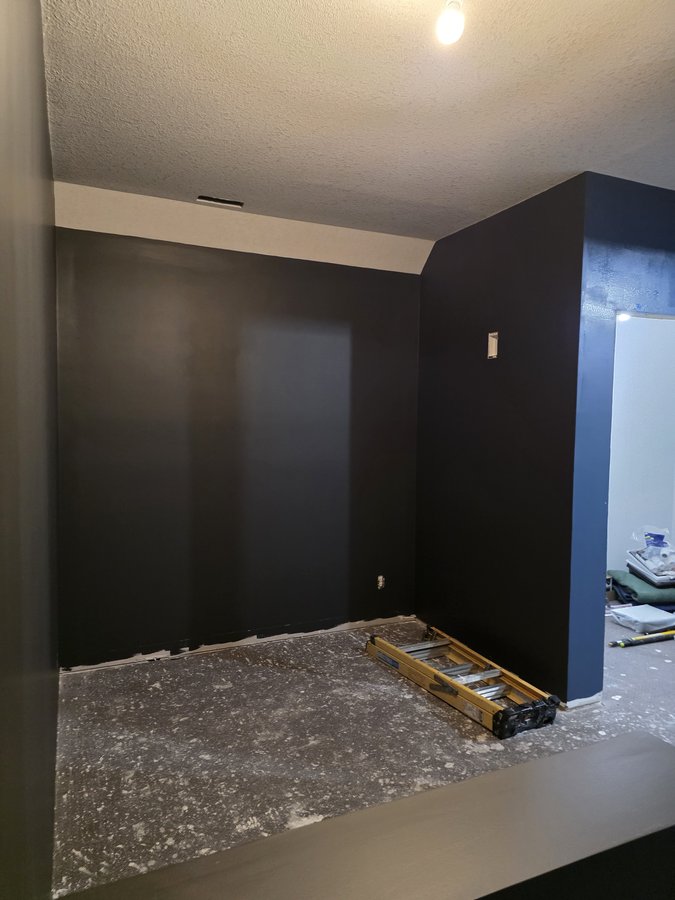 Chinook Glow paint — service room with charcoal walls and navy accent wall