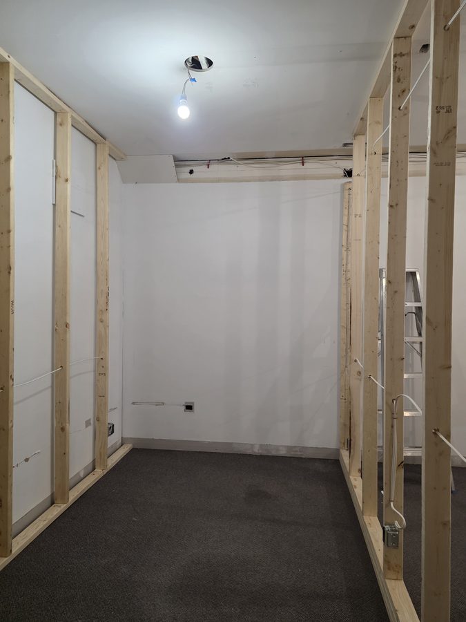 Recovery room before — framed walls and electrical rough-in