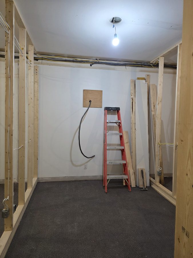 X7 tanning room before — framed walls with buck booster feed roughed in