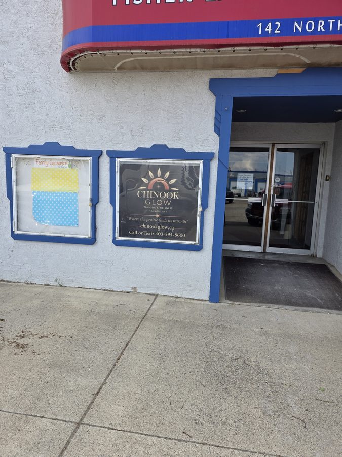 Chinook Glow exterior window sign — 142 Broadway Street North Raymond AB